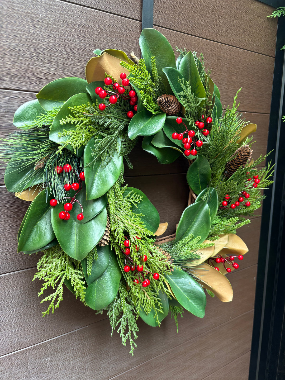 Couronne d’hiver en magnolia, cèdre et baies rouges – 23 po