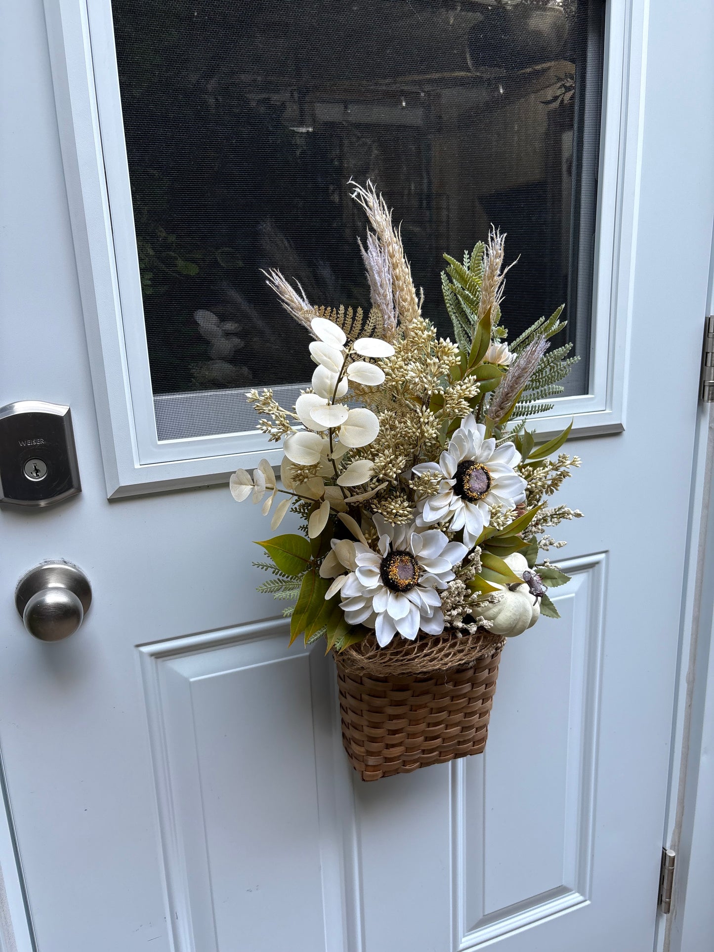Arrangement floral d’automne suspendu sur une porte d’entrée